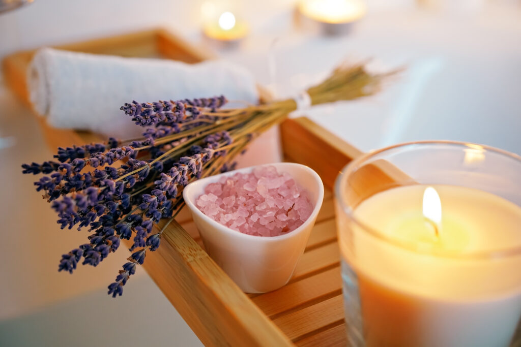 Lighted candle and a lavender bucket, making a spa ambiance in the airbnb. 