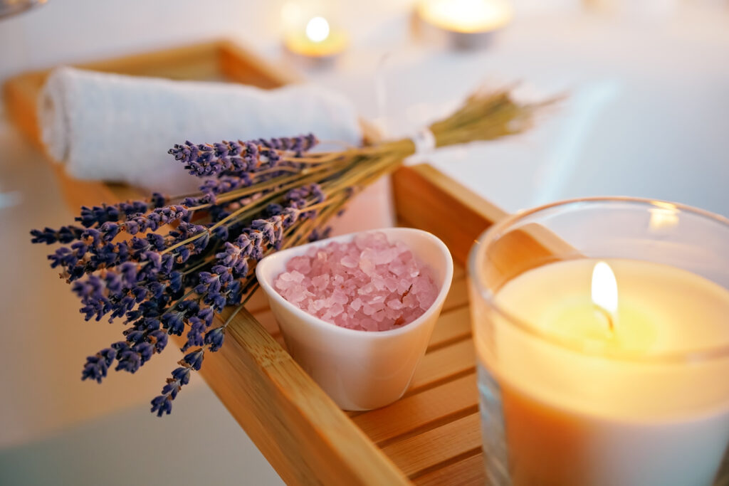 Lighted candle and a lavender bucket, making a spa ambiance in the airbnb.